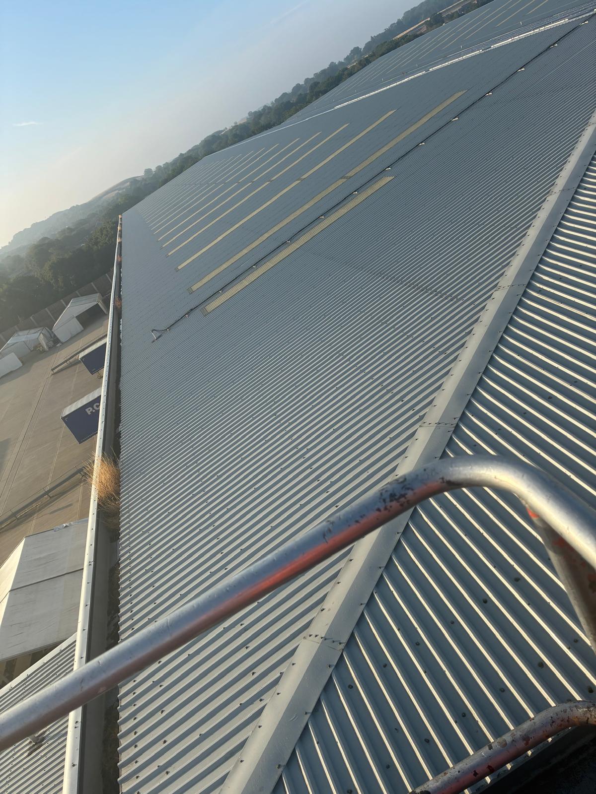 After result of the warehouse box gutter clearing — channel fully cleared and restored to free-draining function